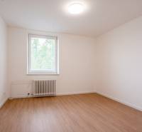Empty room with white walls, floor, and window in a 3-room apartment.
