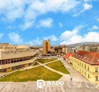 Buildings and greenery in the view on Hviezdoslavova Street in Trenčín, beautiful daytime view.