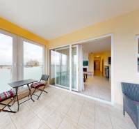 The terrace of the 3-room apartment with furniture and a view provides comfortable seating.