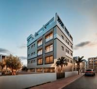 Streets in San Pedro del Pinatar with modern buildings and greenery in front of 3-bedroom apartments.