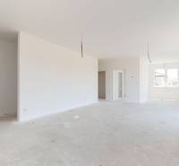 A bright spacious room with white walls in a family house nearing completion.