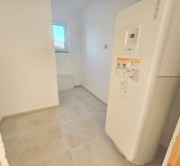Empty room in a family house with white walls and a water tank.