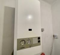 Gas boiler Junkers in the bathroom of a 3-room apartment, next to it is a carbon monoxide detector.