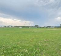 Sports field in Nová Pohora on Nová Pohora Street, surrounded by greenery. Plots - housing.
