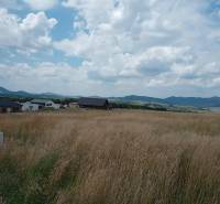 Land - housing in Kunerad, open countryside with houses and hills on the horizon.