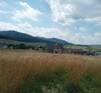 Countryside in Kunerad, Residential Land - with views of mountains and rooftops.