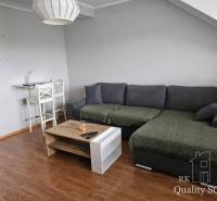 Living room with a sofa and a stool in a 3-room apartment.