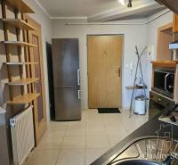 A kitchen in a 3-room apartment with a stainless steel refrigerator and modern appliances.