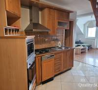 Kitchen and living area with staircase in a 3-room apartment.