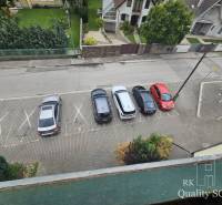 Parking lot on Kysucká Street in Senec with five parked cars near a 3-bedroom apartment.