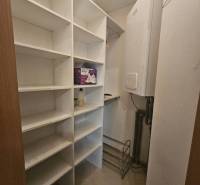 Storage space in a 3-room apartment with shelves and a boiler.