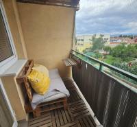 Balcony with wooden flooring and railing in a 3-room apartment on Kysucká Street in Senec.