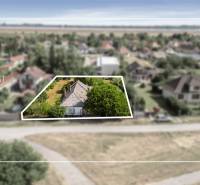 Summer panorama in Dobrohošť with residential plots and surrounding nature.