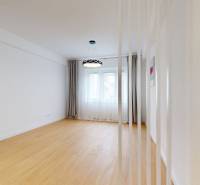Interior of a 2-room apartment with wooden flooring and a pendant light.