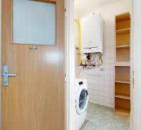 Washing machine, boiler, and storage space in the bathroom of a 2-room apartment.