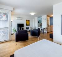 Interior of a 1-room apartment: bright room, furniture, mirror, dining table, air conditioning.