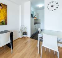 Dining area in a studio apartment with a painting and modern furniture.