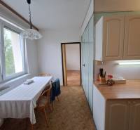 A bright kitchen with a dining table and a window in a 3-room apartment.