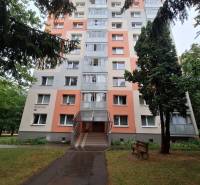 An apartment building on Trenčianska Street in Nová Dubnica surrounded by greenery.