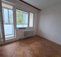 A room in a 3-room apartment with large windows and wooden flooring.