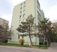Apartment building on Na Revíne Street in Bratislava - Kramáre, surrounded by trees.