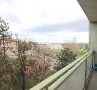 A balcony with a view of nature and urban development in Bratislava on Na Revíne Street.