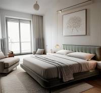 Bright bedroom in a 3-room apartment with a large comfortable bed and an armchair.
