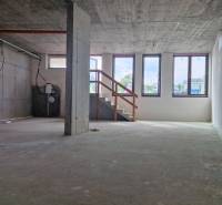 Concrete interior of gastro spaces with a staircase and large windows.
