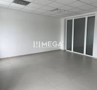 An empty office space with white walls and tiles.