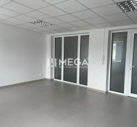 A spacious office with tiles and glass doors, suitable for various purposes.