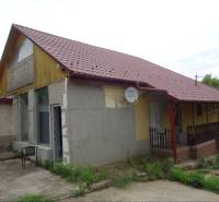 A family house in Leh with a red roof and a satellite dish.