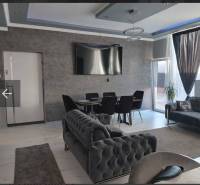 An elegant living space in a family house with comfortable sofas and a television.