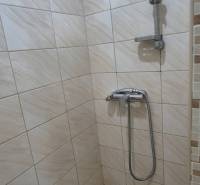 Shower corner with tiles in a studio apartment, without decorations and rugs.