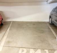 Garage parking between two cars in a 2-room apartment.