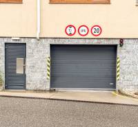 Exterior view of Hečkova garage in Bratislava - Rača with entrance doors and traffic signs.
