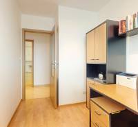 A work corner in a 2-room apartment with a desk and a bookshelf.