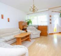 Living room with a large sofa, table, and wooden furniture in a 3-room apartment.