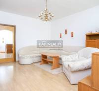 Living room with a corner sofa and wooden furniture in a 3-room apartment.
