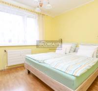 Bright bedroom with a double bed and wooden flooring in a 3-room apartment.