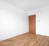 Empty room in a family house with white walls and wooden floor.