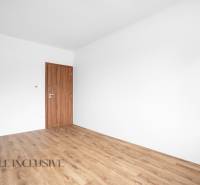 A room in a family house with wooden doors and floor.