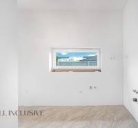White wall with a window and tiles in a family house.