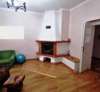 Living room in a family house with a fireplace, sofa, and exercise ball.