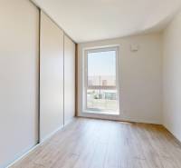 A room in a family house with a built-in wardrobe and a window with a view.