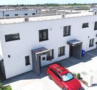 A family house on Obchodná Street in Hviezdoslavov, with a flat roof and a parking space.