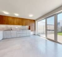 A kitchen with large windows in a family house, a spacious interior with a view of the garden.
