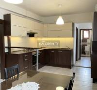 Kitchen and dining area in a family house with modern furnishings and wooden furniture.