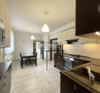 Kitchen with a dining table and modern equipment in a family house.