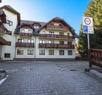 Apartment building with parking and balconies on the street in Donovaly.
