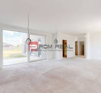 Spacious interior of a family house with large windows and an unfurnished floor.